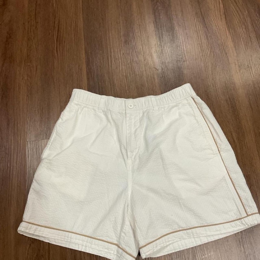 Todd Snyder white shorts with thin brown piping along the side seams